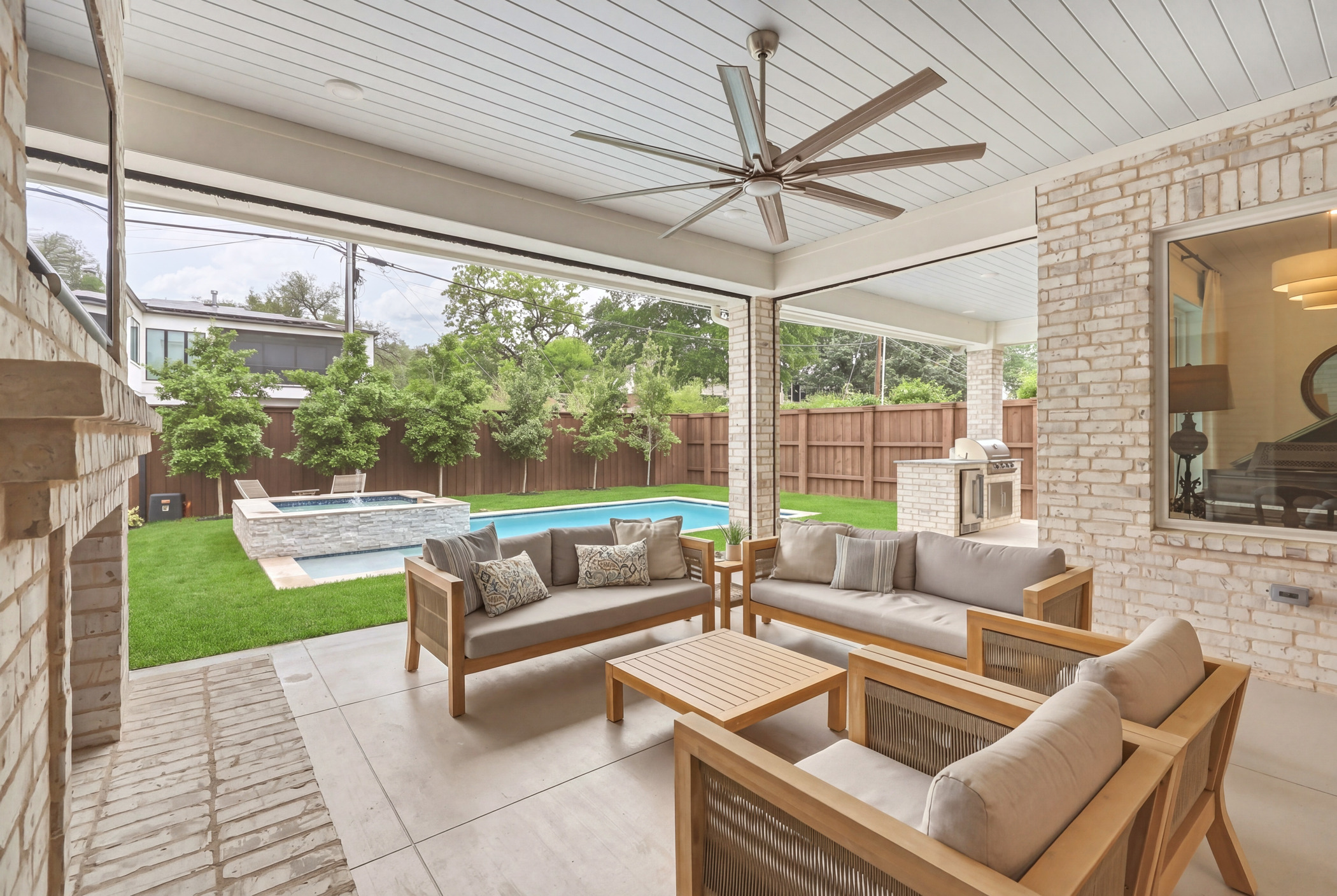 Covered patio with pool, spa, and outdoor kitchen